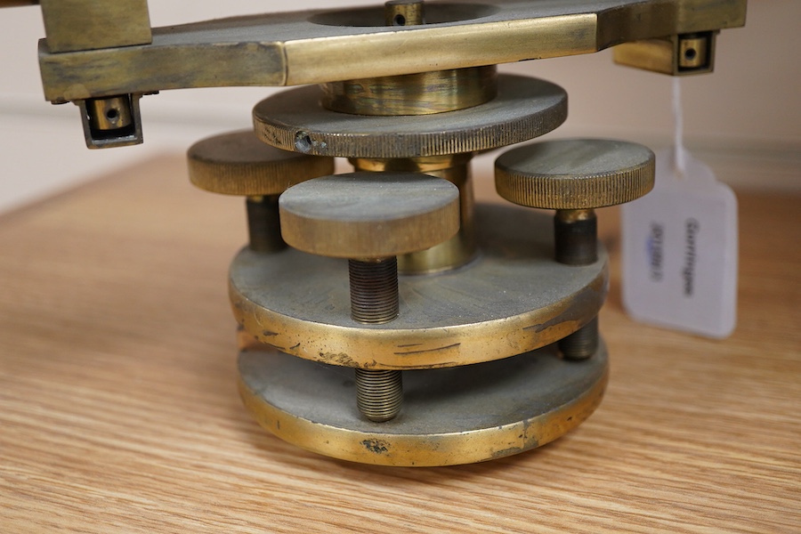 A late 19th century lacquered brass level, by R.W. Street & Co., Commerce Rd., Lambeth, with an incorporated 16 inch telescope, with an ash tripod, uncased, 41cm long